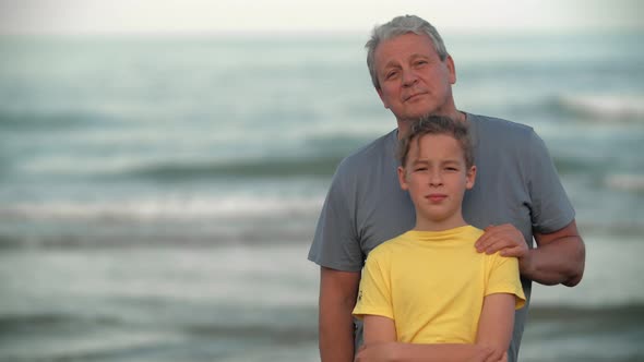 Teenager Boy with Grandfather By the Sea