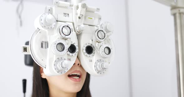 Young Woman doing eye test in clinic