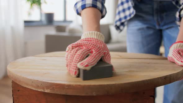 Woman Sanding Old Round Wooden Table with Sponge