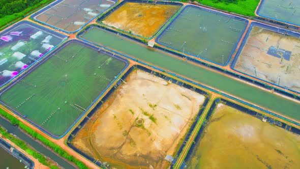 An aerial view over a drone flying over a large shrimp farm