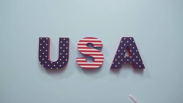 Painted USA sign with white, red and blue on blue background.