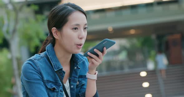 Woman hold with mobile phone in city