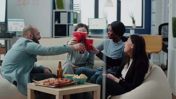 Multi Ethnic Group of People Clinking Cups and Bottles