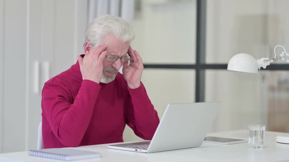 Old Man Having Headache While Working on Laptop