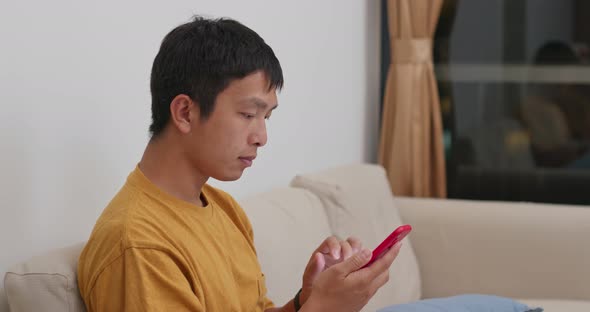 Man use of cellphone at home
