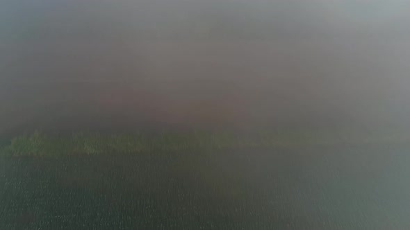 Aerial View of an Early Morning Fog Settling over Farmland Fields