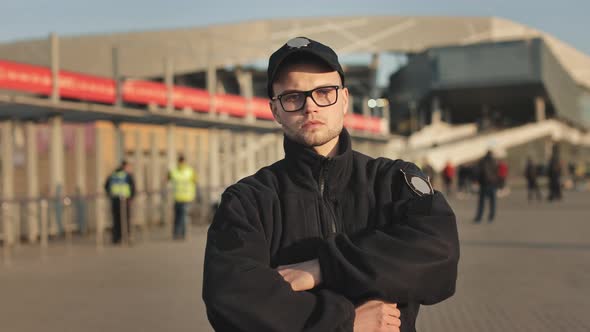 A Man in a Police Uniform is Standing and Looking at the Camera