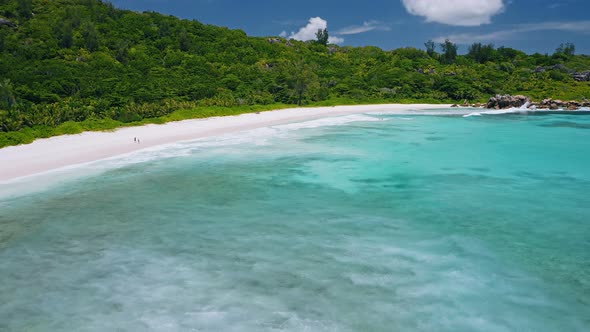 Aerial View of Tropical Paradise Beach Anse Coco with Wide Blue Lagoon. White Sand Coastline and