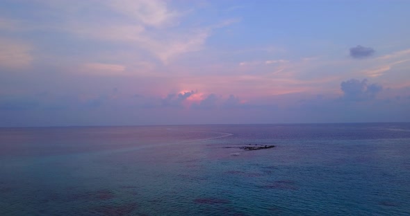 Natural birds eye tourism shot of a paradise sunny white sand beach and blue water background 