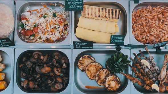 Various Street Food Is Sold on Display Case at Festival. Street Market on Party