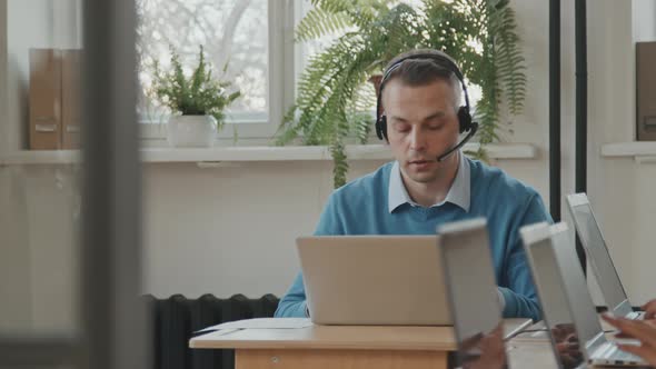 Man Talking to Customer at Call Center