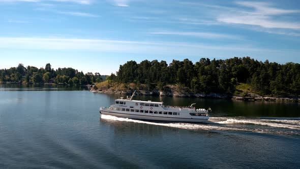 Small Cruise Ship or a Yacht Going Down the Narrow River or Canal