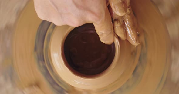 Hands's Potter Making Bowl In Pottery Workshop
