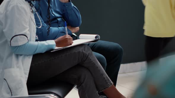 Senior Man with Disease Speaking to African American Medic