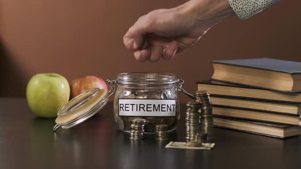 Male Taking Money From Glass with Savings