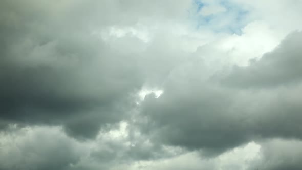 White clouds fly across a bright blue sky