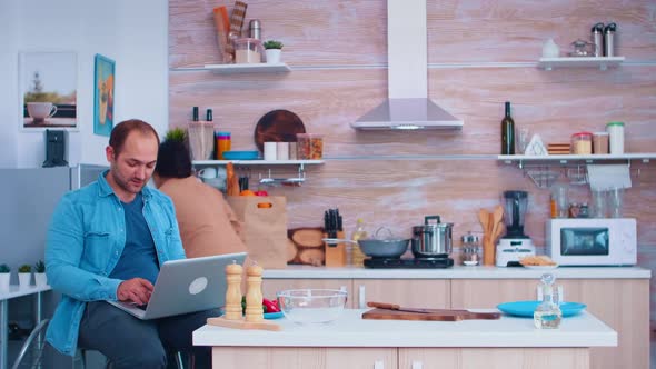 Couple Looks at Recipe on Laptop