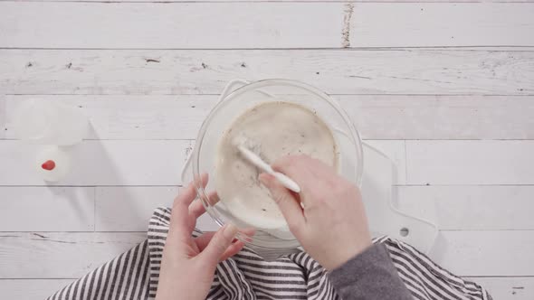 Time lapse. Flat lay. Preparing homemade chocolate ganache for chocolate raspberry cupcakes.