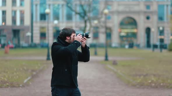 A Young Photographer Takes Pictures in Autumn Weather
