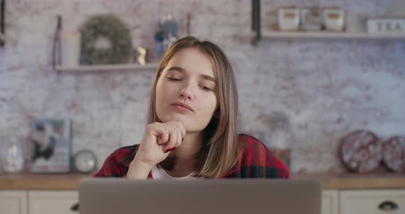 A Young Girl Is Thinking Near Laptop, Work at the Leptop