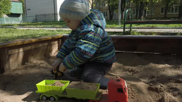 Toddler Boy Playing in Sandbox