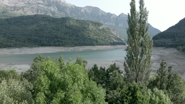 Aerial View Forwarding Shot From Over Forest Surrounding of the Severely Receding Water Levels of