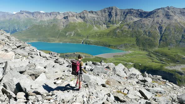 One person hiking on mountain top, Summer adventures on the Alps