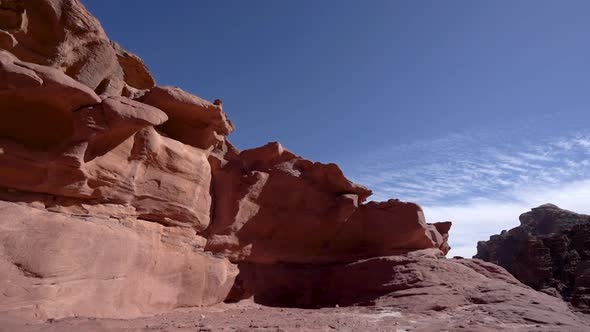 A Timelapse of Blue Sky and Clouds Moving on a Sunny Day Above Red Rock Desert Hill in Wadi Rum