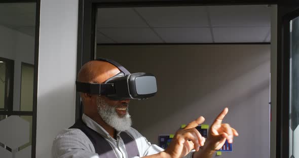 Businessman using virtual reality headset in the office