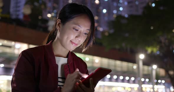 Young woman use of mobile phone at night