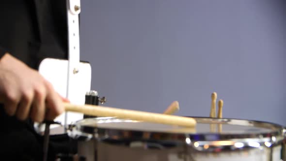 Music Band Participant Plays Drum at Hockey Match at Stadium