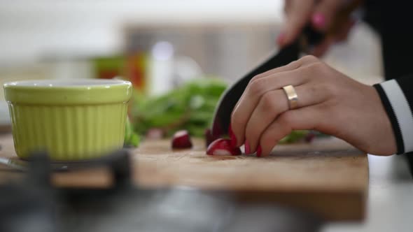 Woman Cutting Red Radishes