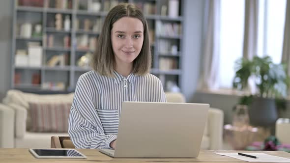 Smiling Young Woman Looking at the Camera in Office 