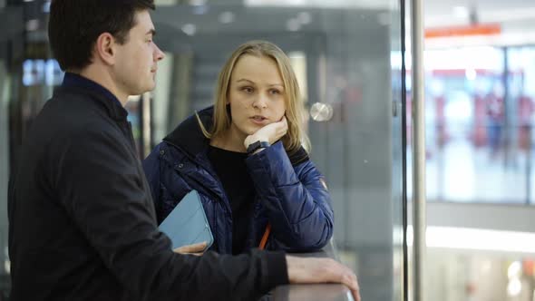 Man and woman discussing something in trade center