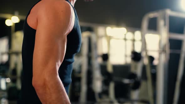 Close-up of Athletic Young Man with Muscular Wiry Body Doing Weight Lifting.