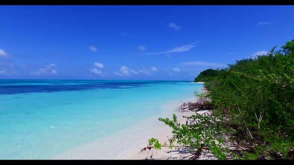 Aerial landscape of beautiful island beach holiday by aqua blue lagoon with white sandy background o