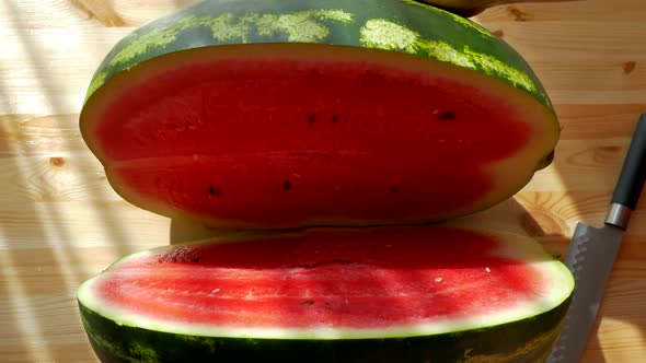 Cut the Watermelon with a Knife. Large Ripe Red Fruit. Vitamins in Summer From Nature