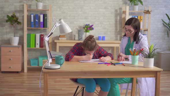 Child Is Autistic and the Doctor in a White Coat in a Medical Office Close Up