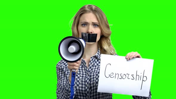 Woman with Taped Mouth Holding Megaphone