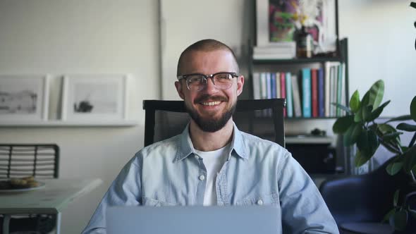 Confident Happy Businessman Wearing Glasses Looking at Camera Sitting in Office with Laptop Spbd