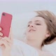 Young Sweet Woman Lies in Bed and Speaks Via Video Link - VideoHive Item for Sale