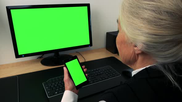 Old Caucasian Woman Works on Computer and Smartphone in Home - Green Screen