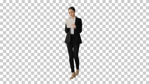 Businesswoman using a tablet pad while walking, Alpha Channel