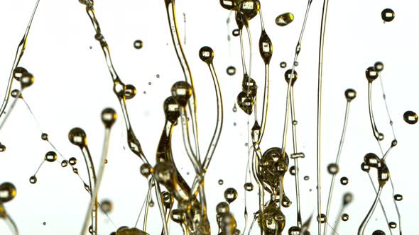 Super Slow Motion Shot of Splashing Oil Isolated on White Background at 1000Fps.