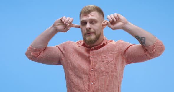 Young Man Plugging His Ears