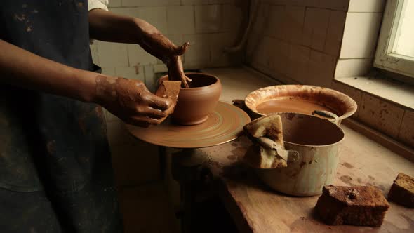 Unrecognized Artist Sculpting on Potters Wheel