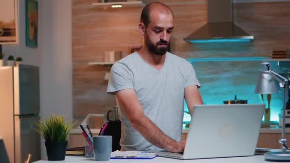 Businessman Checking Hour and Closing Pc