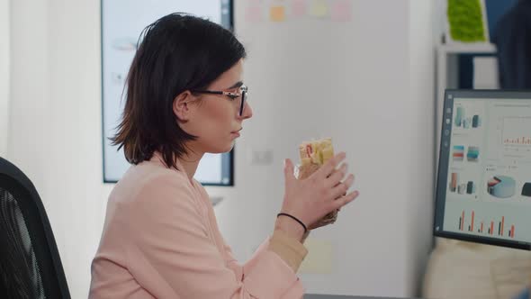 Entrepreneur Woman Eating Tasty Sandwich Having Meal Break Working in Business Company