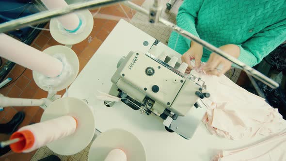 Top View of a Sewing Machine Getting Operated By a Textile Worker