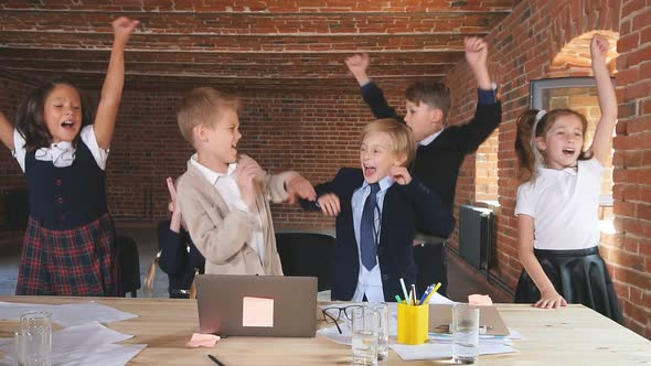 Positive Cheerful Children Rejoicing at Successful Business